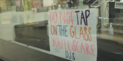 Do Not Tap on Glass sign at college radio station KCSU. Photo: J. Waits