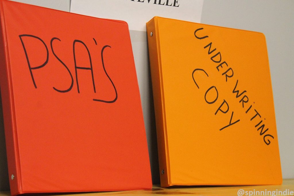 Binders for PSA and underwriting announcements at KPSQ-LP. Photo: J. Waits