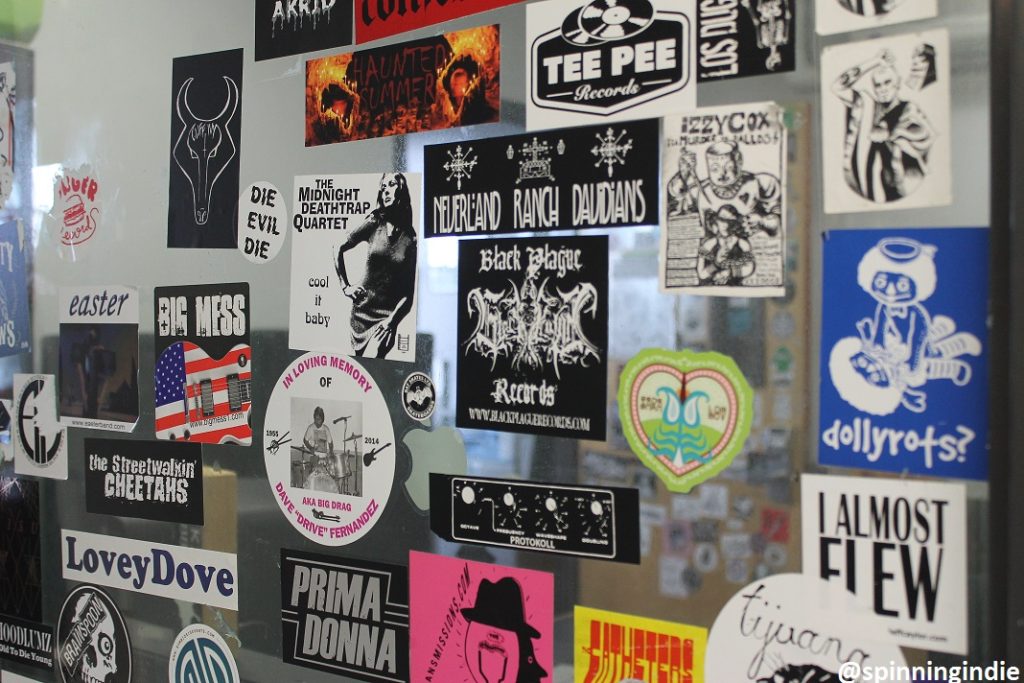 Sticker-covered window at college radio station KXLU. Photo: J. Waits