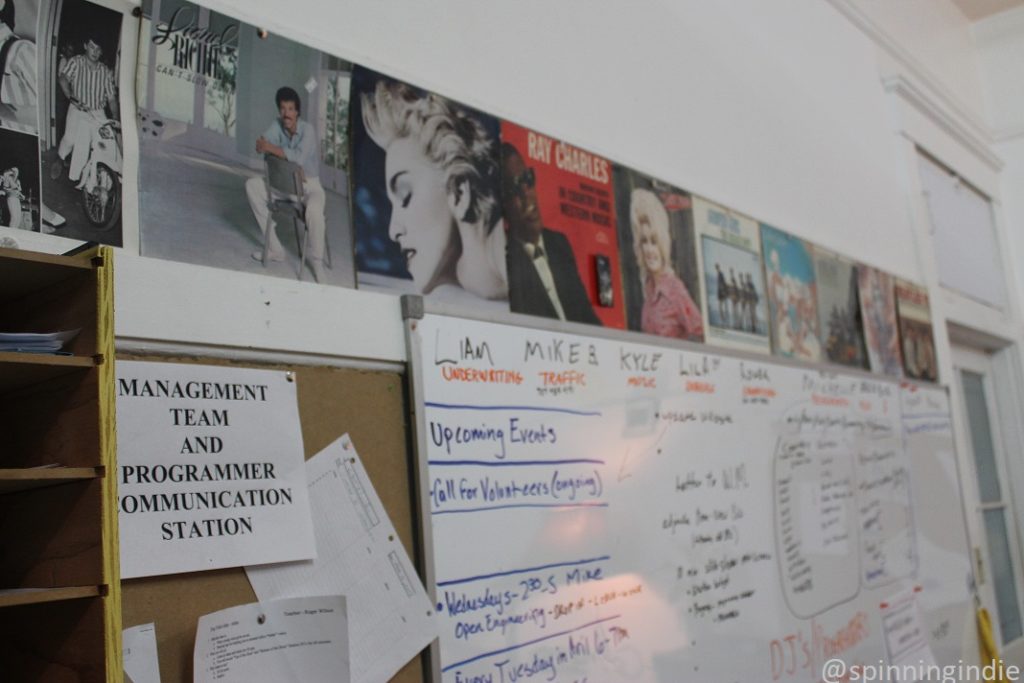 Album covers above bulletin board and white board at KLLG-LP. Photo: J. Waits/Radio Survivor