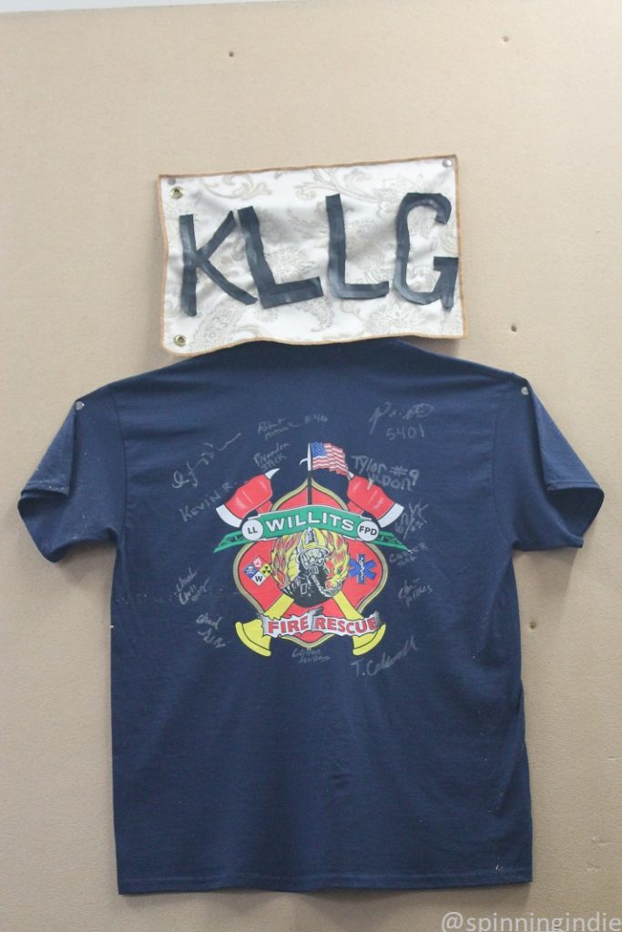 Signed Willits Fire Rescue T-shirt on wall of KLLG-LP in April, 2017. Photo: J. Waits/Radio Survivor