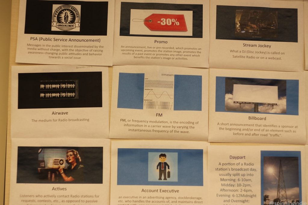 Radio terms defined on wall of classroom: PSA, promo, stream jockey, airwave, FM, billboard, actives, account executive, and daypart. Photo: J. Waits/Radio Survivor