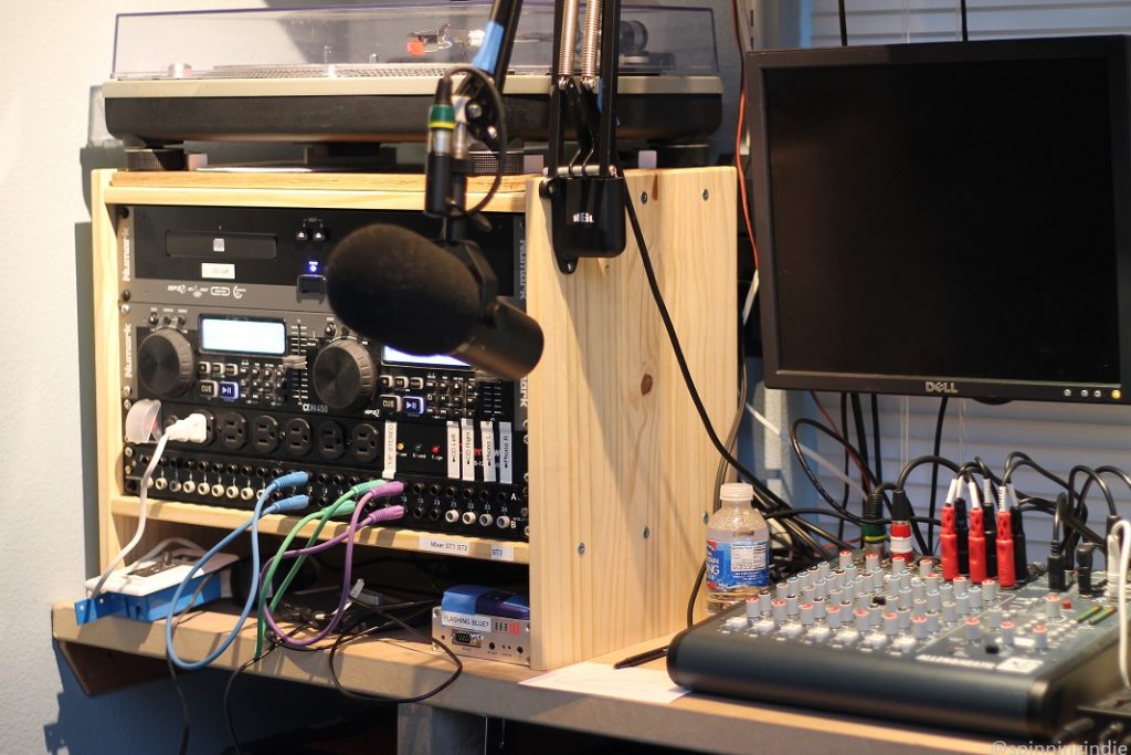 Audio equipment in KBFG's Shack, including turntable, CD players, mixing board, microphone, and monitor. Photo: J. Waits/Radio Survivor