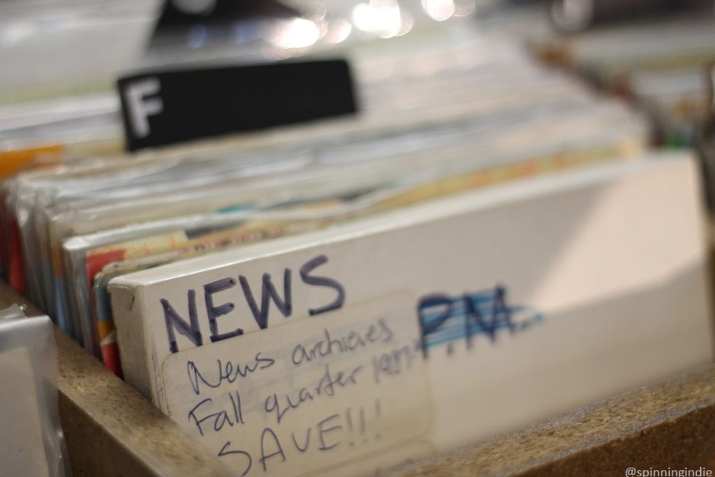 News archives in reel-to-reel tape box amid KSDT 7" records. Photo: J. Waits/Radio Survivor