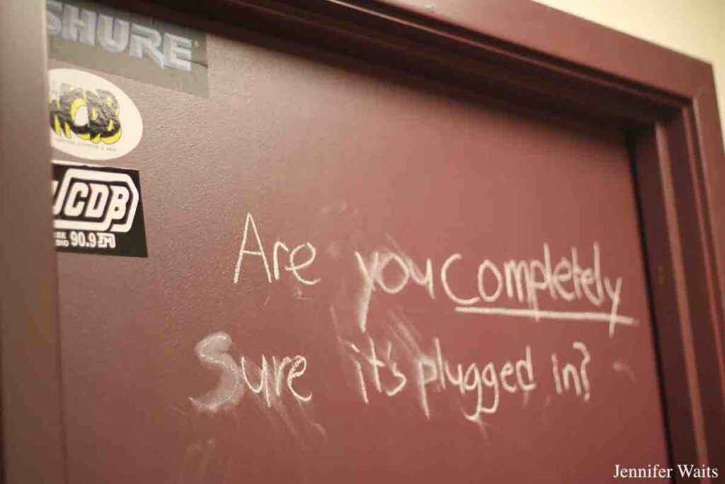 Helpful note at WCDB. "Are you completely sure it's plugged in?" is handwritten on a door. Photo: J. Waits