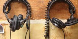 photo of two pairs of headphones hanging on a wall at college radio station WRPI. Photo by J. Waits