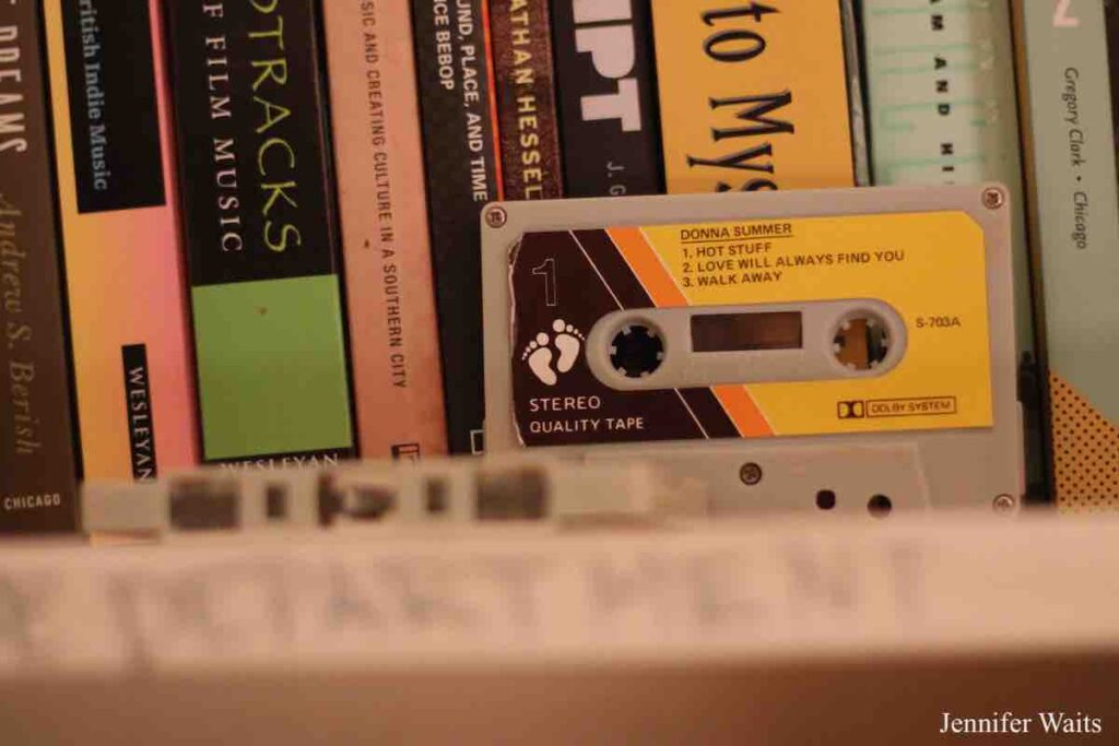 Photo of Donna Summer cassette tape in front of a shelf of books at college radio station WXBC. Photo: J. Waits