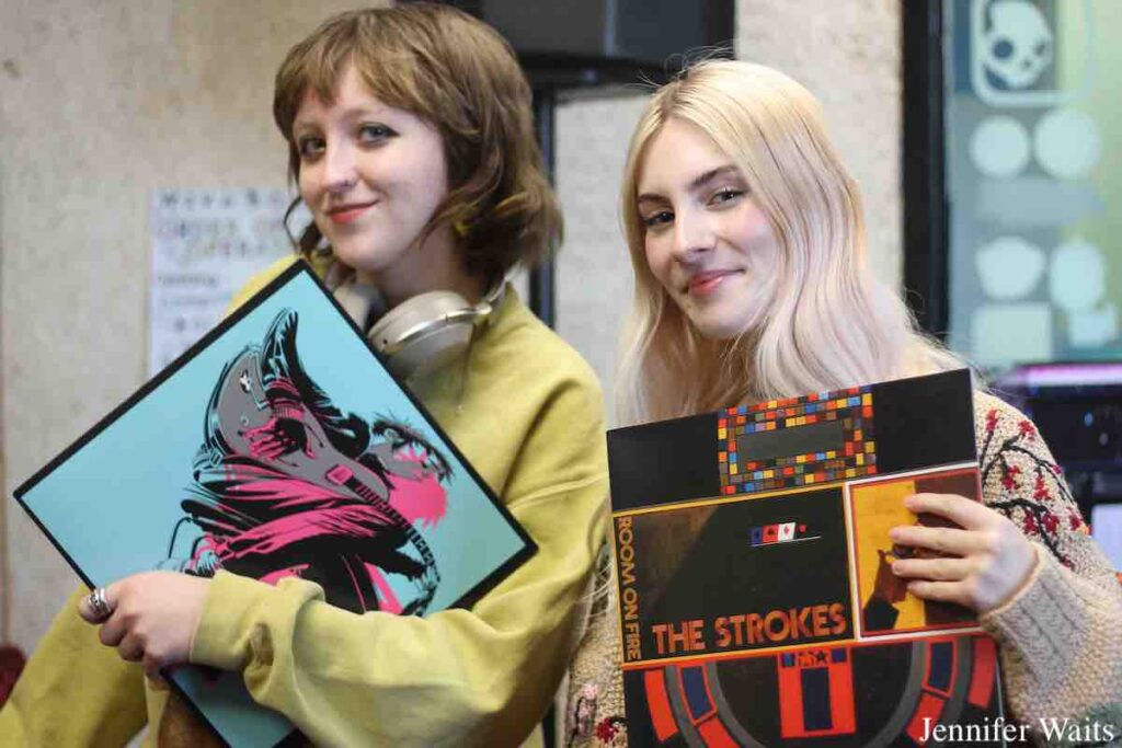 WSVA managers Alice Katok and Michelle Mullin at the station in March, 2023. Both are holding up vinyl LPs. Photo: J. Waits