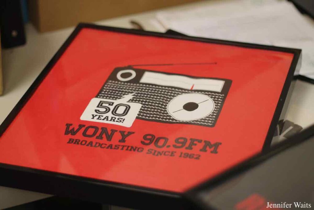 Photo of a framed red t-shirt that has an image of a transistor radio and the words "50 Years! WONY 90.9 FM broadcasting since 1962." Photo: J. Waits
