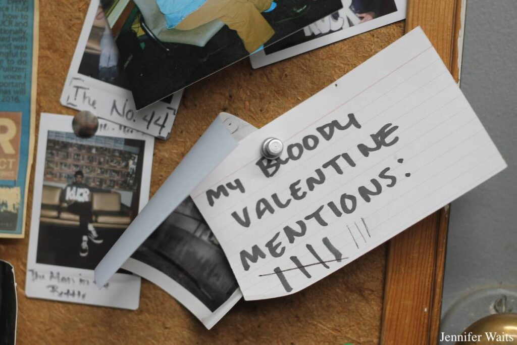 Photo of bulletin board at college radio station KUCR. An index card on the board has "My Bloody Valentine Mentions" written on it, with 8 tally marks. Photo: J. Waits